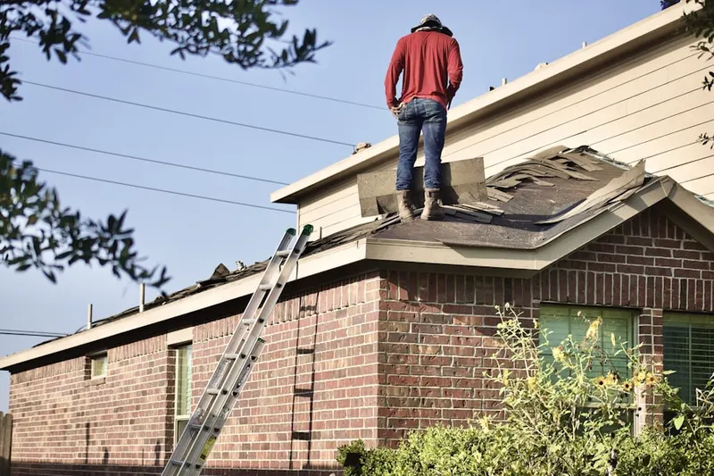 Professional roofer working on a residential roof in Campus Heights
